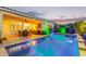 Beautiful backyard with a pool, covered patio, TV, and outdoor dining area, offering a perfect space for leisure and entertainment at 2618 E Stacey Rd, Gilbert, AZ 85298