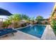Backyard pool with patio, lush landscaping, and inviting lounge areas, designed for ultimate relaxation and enjoyment at 2618 E Stacey Rd, Gilbert, AZ 85298