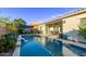 Inviting backyard featuring a pool with a waterfall, patio, and outdoor dining space, perfect for outdoor relaxation and entertaining at 2618 E Stacey Rd, Gilbert, AZ 85298
