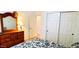 Open bedroom with an inviting dresser, a mirror, and closet with sliding doors, all with ample lighting at 2894 N Paisley Ave, Casa Grande, AZ 85122