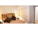 Bright bedroom with a wood headboard and a closet with sliding doors that maximize space at 2894 N Paisley Ave, Casa Grande, AZ 85122