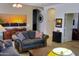 Comfortable living room with neutral walls, couches, and a view to the kitchen at 2894 N Paisley Ave, Casa Grande, AZ 85122