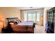 Main bedroom featuring a bay window, chaise lounge, and comfortable decor at 2894 N Paisley Ave, Casa Grande, AZ 85122