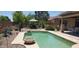 Inviting backyard featuring a serene pool, comfortable seating area, and lush landscaping at 2894 N Paisley Ave, Casa Grande, AZ 85122
