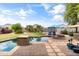 The gorgeous backyard includes a sparkling pool, a fire pit, and plenty of room for outdoor enjoyment at 35952 W Catalonia Dr, Maricopa, AZ 85138