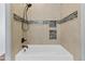 Close-up of bathroom tub with shower head and tiled accent wall, showcasing modern fixtures at 35952 W Catalonia Dr, Maricopa, AZ 85138