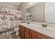 Bathroom boasts double sinks, wood cabinets, and a decorative shower curtain at 35952 W Catalonia Dr, Maricopa, AZ 85138