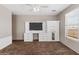Bedroom with a built-in entertainment center, neutral carpet, and a window for natural light at 35952 W Catalonia Dr, Maricopa, AZ 85138