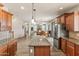 Spacious kitchen with wood cabinets, granite counters, stainless steel appliances, large island, and open layout at 35952 W Catalonia Dr, Maricopa, AZ 85138