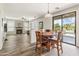 Open concept living area boasts wood flooring, fireplace, and views of the backyard pool through sliding glass doors at 35952 W Catalonia Dr, Maricopa, AZ 85138