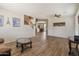 Open living room with wood-look tile flooring, neutral paint, staircase, dining area, and natural light at 35952 W Catalonia Dr, Maricopa, AZ 85138