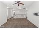 An open living space featuring neutral paint, carpet, and a ceiling fan at 35952 W Catalonia Dr, Maricopa, AZ 85138