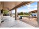 Covered patio showcasing an outdoor entertainment space with view of pool, a fire pit, and landscaped backyard at 35952 W Catalonia Dr, Maricopa, AZ 85138