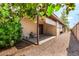The backyard features a covered patio, gravel landscaping, and mature trees, offering a private outdoor space at 440 S Parkcrest -- # 145, Mesa, AZ 85206