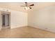 Neutral bedroom with tile flooring, a ceiling fan, and a closet space is bathed in sunlight at 440 S Parkcrest -- # 145, Mesa, AZ 85206