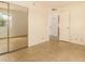Bright bedroom featuring tile floors, a closet with mirrored doors, and a view into an open doorway at 440 S Parkcrest -- # 145, Mesa, AZ 85206