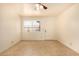 Sun-filled bedroom featuring tile floors, neutral walls, and a ceiling fan and a window at 440 S Parkcrest -- # 145, Mesa, AZ 85206