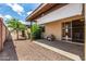 Back exterior showcasing the patio with a sliding door and manicured landscaping at 440 S Parkcrest -- # 145, Mesa, AZ 85206