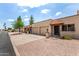 A row of charming townhomes with well-kept yards and a shared driveway showcases an inviting neighborhood feel at 440 S Parkcrest -- # 145, Mesa, AZ 85206