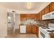 Kitchen featuring dark wood cabinets, granite countertops, white appliances and tile backsplash at 440 S Parkcrest -- # 145, Mesa, AZ 85206