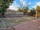 Spacious backyard featuring a covered patio, xeriscaping, and block wall fencing at 4534 E Villa Maria Dr, Phoenix, AZ 85032