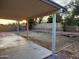 View of the covered patio and the spacious backyard with desert landscaping at 4534 E Villa Maria Dr, Phoenix, AZ 85032