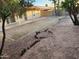 Spacious backyard with a covered patio, block wall, and natural desert landscaping at 4534 E Villa Maria Dr, Phoenix, AZ 85032