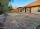 Spacious backyard featuring a covered patio, xeriscaping, and block wall fencing at 4534 E Villa Maria Dr, Phoenix, AZ 85032