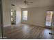 Bright bedroom with a ceiling fan, wood-look flooring, and an ensuite bathroom at 4534 E Villa Maria Dr, Phoenix, AZ 85032