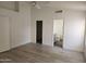 Clean bedroom featuring neutral decor, wood-look floors, closet and bathroom access at 4534 E Villa Maria Dr, Phoenix, AZ 85032