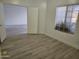 Bright bedroom features wood-look floors, a large window, and an open doorway at 4534 E Villa Maria Dr, Phoenix, AZ 85032