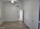 Bright bedroom with wood-look floors, white walls, vaulted ceiling, and a ceiling fan at 4534 E Villa Maria Dr, Phoenix, AZ 85032
