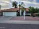 Charming single-story home featuring a terracotta-tiled roof and a well-manicured front yard at 4534 E Villa Maria Dr, Phoenix, AZ 85032