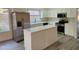 Well-lit kitchen equipped with stainless appliances, white cabinets, and tiled island at 4534 E Villa Maria Dr, Phoenix, AZ 85032