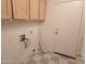 Practical laundry room features wood cabinets, vinyl floors, and appliance hookups at 4534 E Villa Maria Dr, Phoenix, AZ 85032
