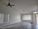 Spacious living room with vaulted ceilings, wood floors, and abundant natural light from large windows at 4534 E Villa Maria Dr, Phoenix, AZ 85032