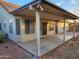 Covered patio features ceiling fan, windows, and concrete floor overlooking the backyard at 4534 E Villa Maria Dr, Phoenix, AZ 85032
