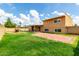 Large fenced backyard includes a patio, lawn, and play structure at 4802 W Hayward Ave, Glendale, AZ 85301