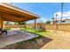 Fenced backyard with covered patio, playground, and lawn at 4802 W Hayward Ave, Glendale, AZ 85301