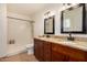 Bathroom featuring a double sink vanity with granite countertops and a walk-in shower at 4802 W Hayward Ave, Glendale, AZ 85301
