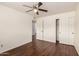 Spacious bedroom with wood-look floors, closet with white doors, and ceiling fan at 4802 W Hayward Ave, Glendale, AZ 85301