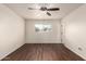 Bright bedroom features wood-look floors, a ceiling fan, and a window offering natural light at 4802 W Hayward Ave, Glendale, AZ 85301