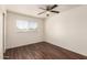 Bedroom features wood-look floors and a window offering natural light at 4802 W Hayward Ave, Glendale, AZ 85301