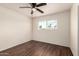 Bedroom featuring wood-look floors, a ceiling fan, and natural light from the window at 4802 W Hayward Ave, Glendale, AZ 85301