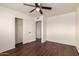 Bedroom with ceiling fan, wood-look floors, closet, and white walls at 4802 W Hayward Ave, Glendale, AZ 85301