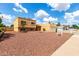 Tan home with a red rock yard, garage, and beautiful blue sky at 4802 W Hayward Ave, Glendale, AZ 85301