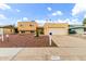 Charming two-story tan home with a two-car garage and desert landscaping at 4802 W Hayward Ave, Glendale, AZ 85301