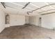 Attached two car garage featuring an automatic door, shelving, and water heater at 4802 W Hayward Ave, Glendale, AZ 85301