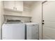 Functional laundry room with washer, dryer and upper cabinet storage at 4802 W Hayward Ave, Glendale, AZ 85301