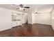 Living room with hardwood floors, ceiling fans, wet bar, and staircase at 4802 W Hayward Ave, Glendale, AZ 85301